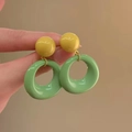 Detail of hand holding French vintage yellow and green resin round dangle earrings - 25# Silver Earring Post-Green (Yellow Green Hoop)