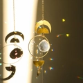 Golden moon suncatcher with a faceted crystal ball reflecting colorful light spots - Style 26