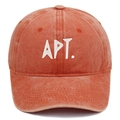 Macro detail of APT. embroidery and vintage washed cotton texture on orange baseball cap - Orange