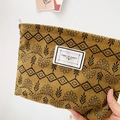 Ginger yellow corduroy makeup bag with floral patterns and Time To Party label - Toffee Plants