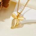 Elegant gold bow pendant necklace with opal stones and crystals on a silk background - Gold White Stone Bow Single Diamond Style (T015)
