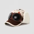 Close-up of kids winter pilot hat featuring corduroy fabric and warm fleece earflaps - 52cm (2-5 Years) / Dinosaur Print-Coffee