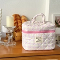 Detailed view of pink and yellow quilted cotton cosmetic bag with handle and zipper - Yellow Pink