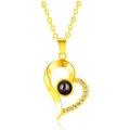 Golden heart-shaped projection necklace with white pavé crystals and black stone bead - Slanted Heart Gold