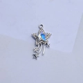 Macro detail of silver star pendant with rhinestones and iridescent center - White Zirconia