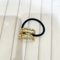 Minimalist gold alloy hair tie with sleek streamlined geometric wave design and black band - Hollow Gold