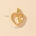 Detailed close-up of a gold heart pendant with zircon frame and cross, size 2.2x1.6cm - Style Z-Clear Zirconia Heart with Cross