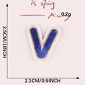 Royal blue embroidered letter V patch with white border measuring 2.5cm by 2.3cm - Letter-V