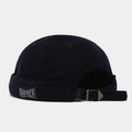 Detail view of corduroy docker hat featuring adjustable strap and woven side label - Adjustable / Dark Blue