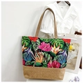 Canvas tote bag featuring tropical floral print with brown burlap bottom and handles - Red Green Colorful