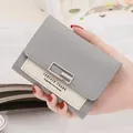 Minimalist short wallet for women featuring a grey and white patchwork design with metal clasp - Gray