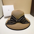 Khaki straw sun hat with wide black and gold stripe bow decoration for women - One Size (Adjustable 55-58.5cm) / Black Bow / 【product Attributes】this Product Is A French Retro-style Straw Sun Hat Primarily Khaki In Color Adorned With A Large Black-and-gold Striped Bow. Its Classic Dome Design Is Highly Fashionable And Decorative. 【visual Presentation】the Image Was Professionally Photographed Using Still-life Display Techniques Against A Minimalist Morandi-colored Background And A White Display Stand. Light And Shadow Are Evenly And Naturally Distributed Resulting In High Image Quality. The Straw Hat's Weave Texture And The Bow's Satin Finish Are Clearly Visible With No Noise Or Overexposure. The Image Is Aesthetically Pleasing With Harmonious Colors And A Stable Composition Possessing Strong Visual Appeal. 【text Content】ocr Detected The Letter "d" Printed On The Background Decorative Gift Box Identifying It As A Scene Decoration Prop. The Entire Image Contains No Chinese Marketing Language Logo Watermarks Or Certification Marks. 【review Conclusion】approved. The Product Display Effect Is Excellent With No Policy Violations Or Infringement Risks. 【logistics Labels】none. 【infringement Risk】none. The White Box With Letters In The Background As A [scene Prop] Is Not Considered For Infringement. The Straw Hat Itself Does Not Have An Obvious Brand Logo Or Design Infringement Features; The Probability Of Infringement Is Assessed As 0.1. [product Parameters] Woven Material Bow Decoration Dome-shaped Flat Brim Sunshade Vacation Style One Size Fits All Adults.