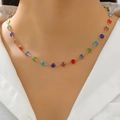 Fashionable golden necklace with colorful round faceted gemstone pendants worn by a model - Gold Multicolor Round Diamond Necklace (4363)