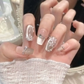 Macro shot of luxury press-on nails with 3D flower petals, cat-eye finish and rhinestones - Extra Small (XS) / Short Coffin