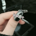 Adjustable silver butterfly ring with pink zircon and white floral stones on finger - Style 8-Flower & Butterfly