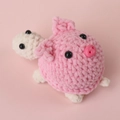 Handmade crochet turtle and pink pig stuffed animal figure on a soft pink background - Little Pink Pig Costume Turtle