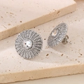 Detailed macro view of silver sunburst stud earrings with pavé set zircon stones - Steel White (KE116359-KFC)