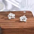 Elegant 925 silver plated lotus flower stud earrings shown on a dark wooden stand - Silver Lotus Shape (A170)