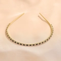 Close-up of golden headband with emerald and white cubic zirconia on silk background - Royal Blue Gold (FG0009-7)