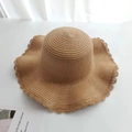Detail of hand-woven straw hat featuring unique scalloped edges and a wide brim design - Kids / Plain Style / Brown