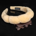 Close-up of handmade yellow velvet sponge headband with luxury texture and logo detail - Twisted Sponge Headband / Champagne