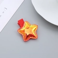 Glittery orange star hair clip for girls with red ribbon trim on a metal duckbill clip - Iridescent Star / Red Star