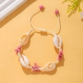 Detail of bohemian hand-woven bracelet with white shells and pink starfish beads - Pink Starfish Woven Style