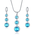 Silver-colored jewelry set featuring halo-set blue sapphire zircons and elegant earrings - Necklace and Earring Set / Sky Blue