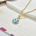 Macro detail of golden Evil Eye pendant with blue enamel on a textured surface - Necklace Set-White