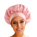 Pink satin sleep cap with wide elastic band for hair protection on white background - Nude Pink