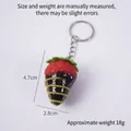 Realistic red strawberry keychain dipped in dark chocolate with green drizzle design - Dark Coffee Jam - Red Strawberry (Keychain)