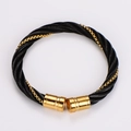Macro detail of black steel cable weave and gold-plated clasp on a hip hop bracelet - Black Gold with Square Details