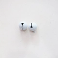 Top-down macro view of white candy-colored 14mm metal bells with small hanging loops - White