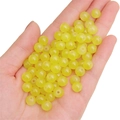 Vibrant yellow round glass beads for DIY jewelry making displayed on a hand - Yellow approx 50pcs/pack