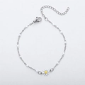 Detailed macro view of 18K gold daisy bracelet with white beads and adjustable lobster clasp - Steel + White Stone