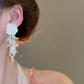 Close-up of white flower tassel earrings with pearls on model in soft warm lighting - White-Shell (14# Silver Pin)