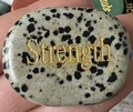 Dalmatian Jasper oval palm stone with golden Strength engraving for inspiration - Dalmatian Jasper