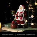 Resin Santa Claus figurine holding a green gift box and candy cane with gift bag - Santa Claus with Cane