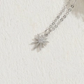 Silver octagonal star pendant necklace with white zircons on a natural stone background - Little Sun / Silver