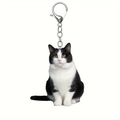 Detail of silver metal lobster clasp and acrylic black and white tuxedo cat keychain - Realistic Sitting Tuxedo Cat