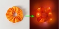 Orange LED hair scrunchie in satin fabric showing glowing effect in light and dark - Lighted-Orange