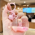 Porte-clés chat rose en forme de biberon avec liquide mobile, paillettes et clochette - Ours à Salopette Biberon / Rose