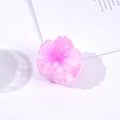 Detailed view of a pink floral hair claw clip with subtle glitter on clear plastic - Pink