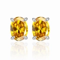 Macro detail of yellow oval-cut zircon earrings with polished silver four-claw setting - 925 Silver / Gold