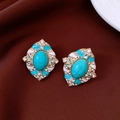 Macro shot of vintage gold-plated oval stud earrings with turquoise stone and rhinestones - Oval Turquoise Texture Style / Silver Earring Post - Gold - Blue