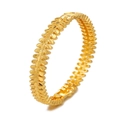 Macro detail of gold flower hollow cuff bracelet with leaf patterns and matte texture - Style 8