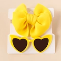 Detail of yellow bow nylon headband and matching heart-shaped sunglasses for kids - Yellow Set