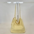 Detail of yellow gingham canvas tote bag with knotted strap on a metal stand - Yellow Plaid