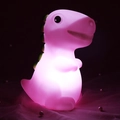 Pink cartoon dinosaur night light glowing softly on a decorative pearl surface - Pink Dinosaur