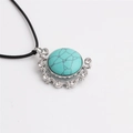 Macro detail of turquoise hamsa pendant with sparkling rhinestones and silver metal finish - Turquoise/Black Rope